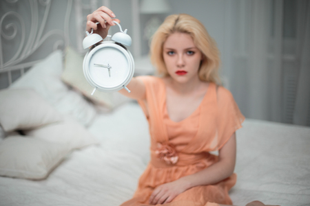 She wants to sleep and sets the alarm.の写真素材