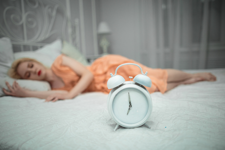 She wants to sleep and sets the alarm.の写真素材