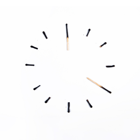 Hours of burnt matches on white background.