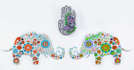 A set of sketches of hamsa and elephants in flowers on a white background.の写真素材