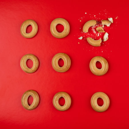 Donuts or bagels group in top view and three rows on red background - delicious bakery snack food