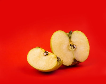 Fresh red apple slice on red background.の写真素材