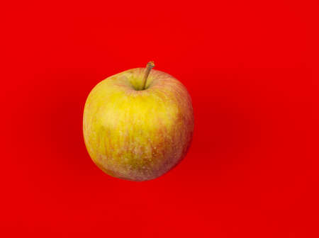 Fresh red juicy apple isolated on red background. High quality photoの写真素材