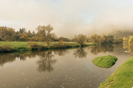 Beautiful view of forest lake in a morning fog, autumn travel. Near the Zbecno village, Czechiaの写真素材