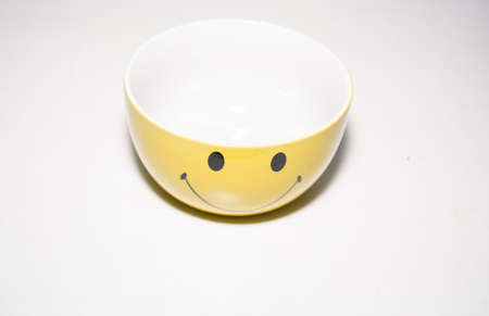 The plate is yellow, with a smile.の写真素材