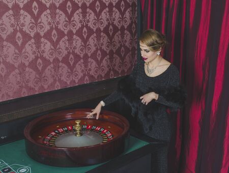 Girl in casino is at the table with a tape measure.の写真素材