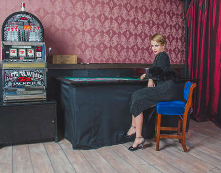 Girl in casino sitting at the table with a tape measureの写真素材