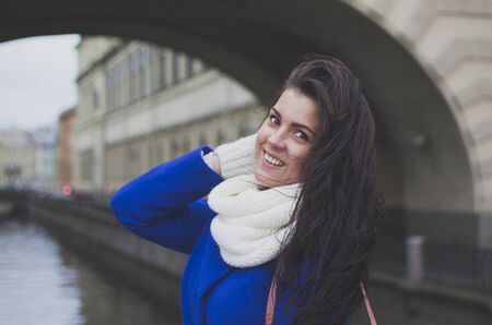 a girl stands by the river in the cityの写真素材