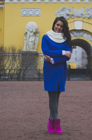 a girl stands in front of a yellow buildingの写真素材