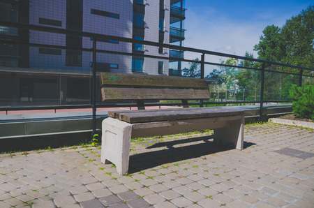 stone bench with wooden seat in the courtyardの写真素材