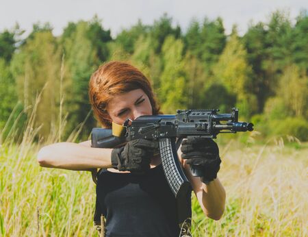 girl soldiers to aim with a machine gun
