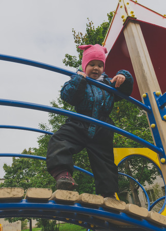 the child looks over the railing of the Playground.の写真素材