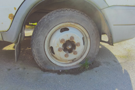 the old machine is in place the punctured wheel from under him sprouted grass.の写真素材