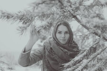 black and white, beautiful girl in a headscarf in the woods in winter.の写真素材