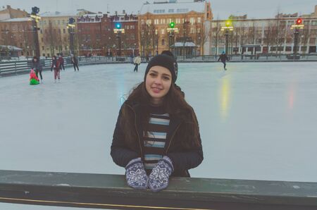 beautiful girl at the rink on a winter's day, alone.の写真素材