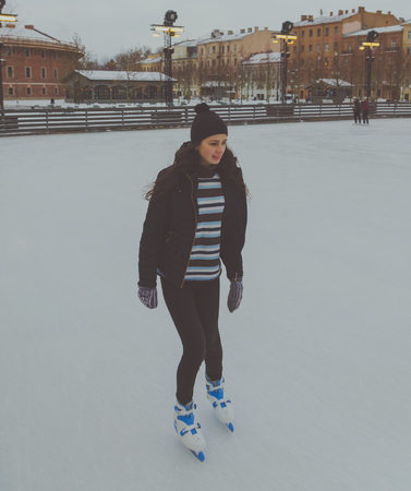 a winter day at the skating rink pretty girl at the rink.の写真素材