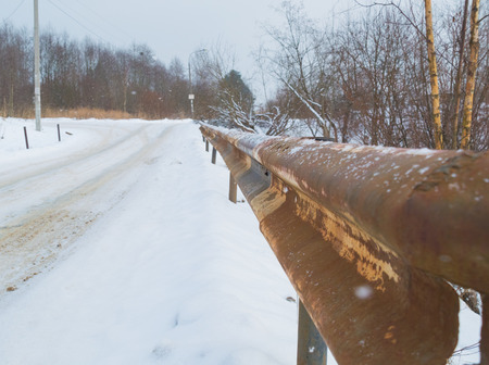 old rusty fence road bump in the winter.の写真素材