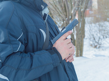 with a gun in the hands of the winter male.の写真素材