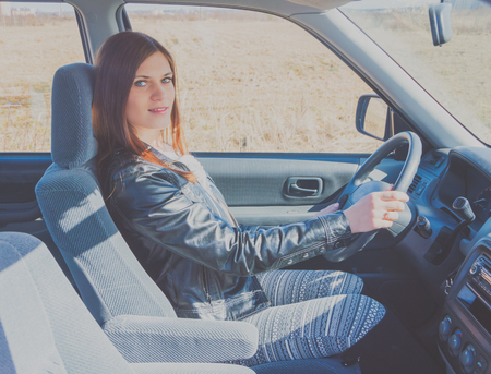 attractive girl in a Sunny day in the car.の写真素材