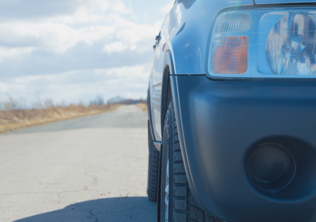 closeup of headlight SUV car on the asphalt road.の写真素材