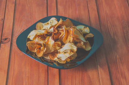dried apples on a wooden table.の写真素材