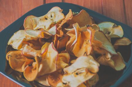 close-up, dried apples on a wooden table.の写真素材