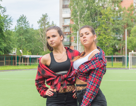 two beautiful girls on the school Playground posing.の写真素材