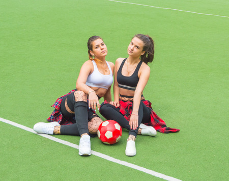 on the football field, two beautiful girls with the ball.の写真素材