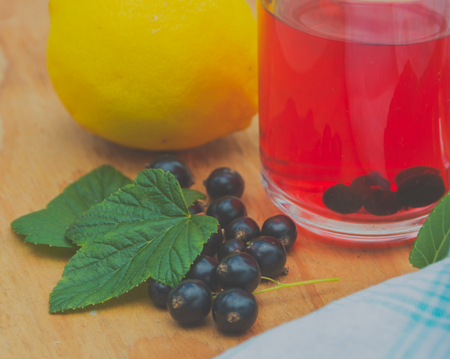 Tea from the berries of black currant with lemon.の写真素材
