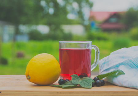 Tea from the berries of black currant with lemon.の写真素材