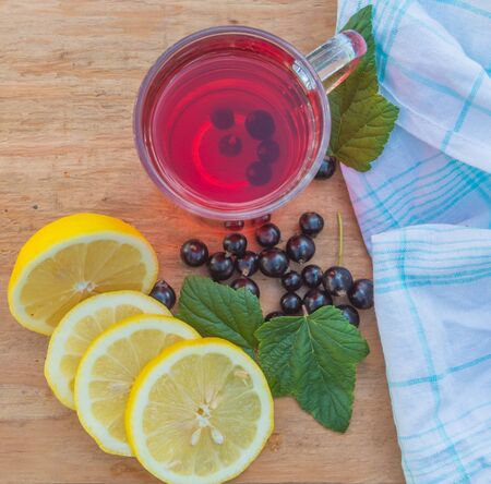 Tea from the berries of black currant with lemon.の写真素材