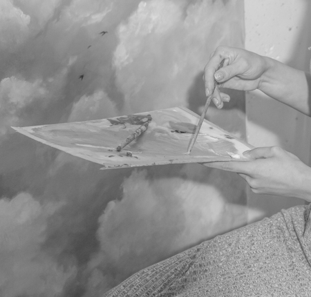 black and white, a palette with paint and brushes in the hands of the artistの写真素材