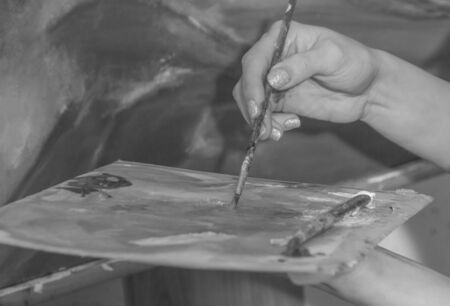 black and white. on the palette, mix the paint.の写真素材