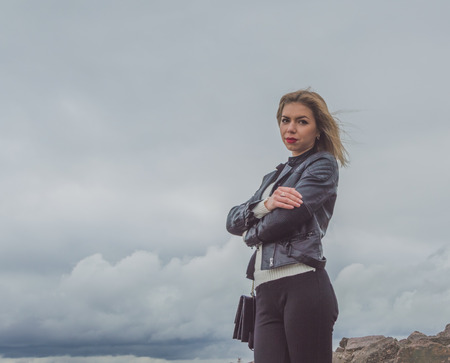 beautiful girl on the background of the autumn skyの写真素材