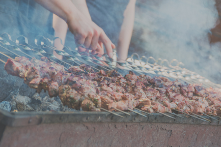 closeup of shish kebab on skewers, the chef preparesの写真素材