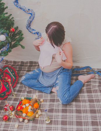 in the new year pregnant girl near Christmas treeの写真素材