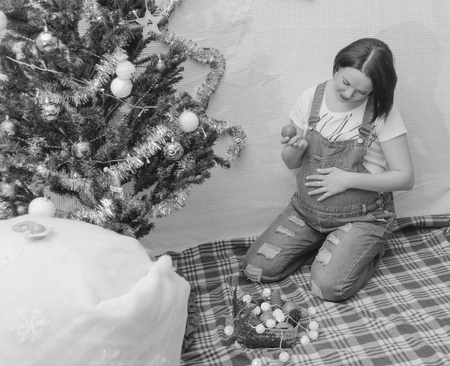 in the new year pregnant girl near Christmas treeの写真素材