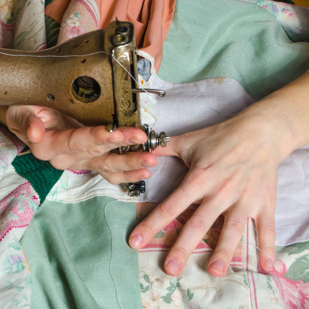 woman embroiders on the sewing machineの写真素材