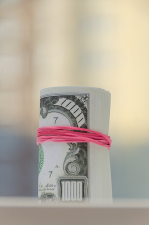 tied with a rubber band pack of one thousand dollarsの写真素材