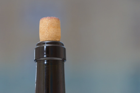 closeup of the neck of a wine bottle closed with cork backgroundの写真素材