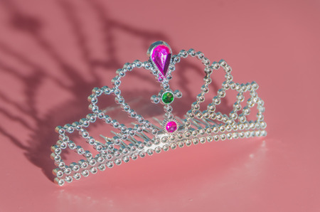 a toy plastic tiara on a pink backgroundの写真素材