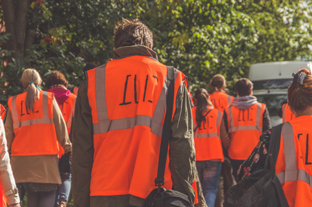 a group of people working in vests on the street