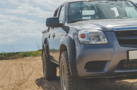 off-road car on desert sand roadの写真素材