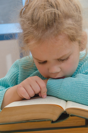 girl, child, elementary school student with a bookの写真素材