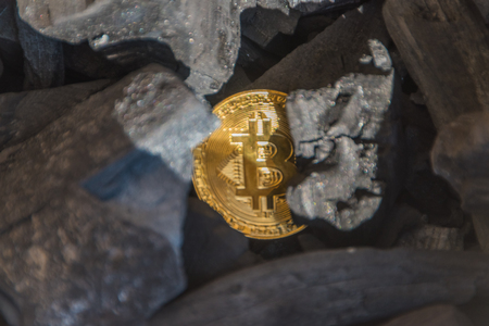 bitcoin coin in the coal, close-upの写真素材
