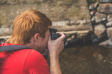 photographer, male, outdoors photographing the stonesの写真素材