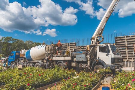 Russia, Leningrad oblast, the city of Nikolskoye, 08 Aug 2018 -construction, cement pouring with machine into the frame of the house, worker, manのeditorial素材