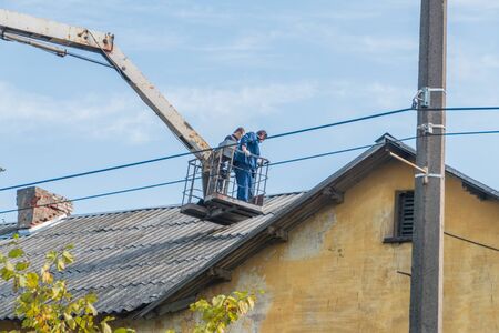 Russia, Leningrad region, Nikolskoe, 20 Sep 2018 - the roof repair shingles, slate with aerial platforms.のeditorial素材