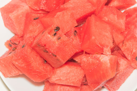 close-up, on a plate are pieces of sliced watermelonの写真素材