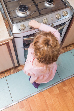 girl, a child includes a gas stove in the absence of adults, the risk of poisoning, fire, explosionの写真素材